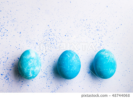 Painted eggs flat lay on a white background. Easter and spring composition. Copy space. Painted eggs flat lay on a white background. Easter and spring composition. Copy space. 48744068
