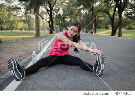 Exercise concept. A beautiful girl is training her body with exe Exercise concept. A beautiful girl is training her body with exe 48744363