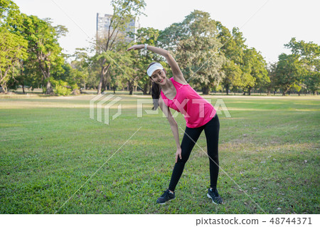 Exercise concept. A beautiful girl is training her body with exe Exercise concept. A beautiful girl is training her body with exe 48744371