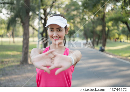 Exercise concept. A beautiful girl is training her body with exe Exercise concept. A beautiful girl is training her body with exe 48744372