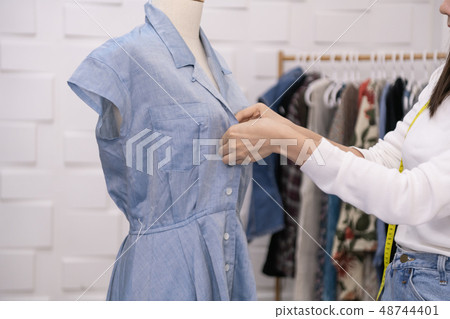 Designer concept. The dressmaker is designing an evening dress i 48744401