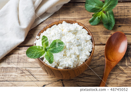 Homemade cottage cheese with mint in a bowl  48745052