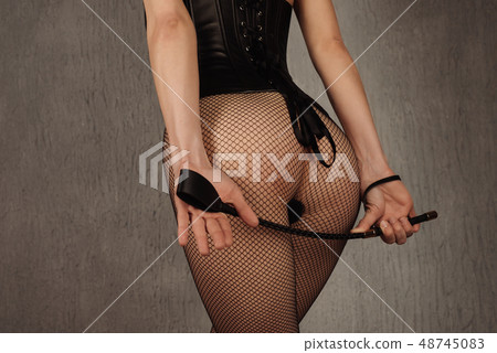 Sexy lady in bdsm outfit. Beauty woman standing Sexy lady in bdsm outfit. Beauty woman standing 48745083