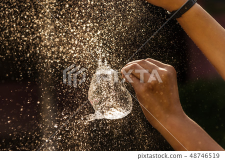 Hand of girl with water splash on black background 48746519