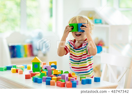 Kids toys. Child building tower of toy blocks. Kids toys. Child building tower of toy blocks. 48747342