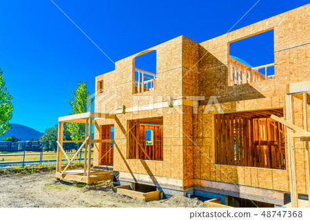 New family house under construction on sunny day. New family house under construction on sunny day. 48747368