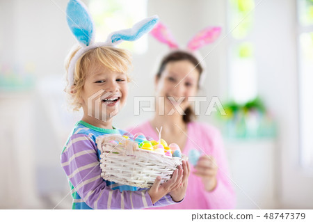 Mother and kids, family coloring Easter eggs. Mother and kids, family coloring Easter eggs. 48747379