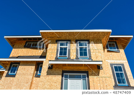 Brand new townhouses building under construction on sunny day in Canada. 48747409