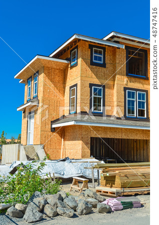 Brand new townhouses building under construction on sunny day in Canada. Brand new townhouses building under construction on sunny day in Canada. 48747416
