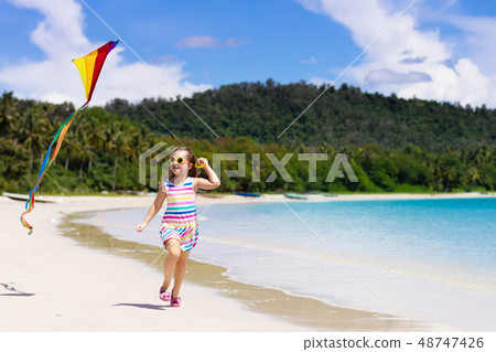Child with kite. Kids play. Family beach vacation. Child with kite. Kids play. Family beach vacation. 48747426