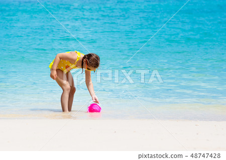 Kids play on tropical beach. Sand and water toy. Kids play on tropical beach. Sand and water toy. 48747428