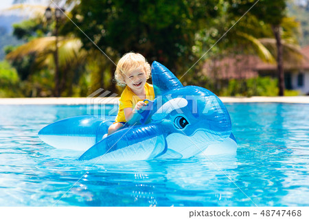 Child in swimming pool. Kid on inflatable float Child in swimming pool. Kid on inflatable float 48747468