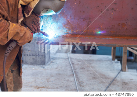 Worker welding in a factory. Welding on an industrial plant Worker welding in a factory. Welding on an industrial plant 48747890