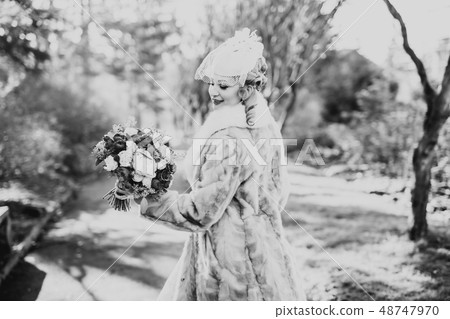 Portrait of stunning bride with long hair posing with great bouquet 48747970