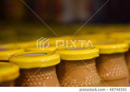Mustard jars in the store 48748391