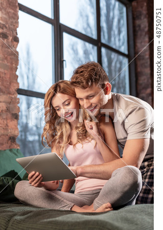 Girlfriend watching movie on tablet with her handsome man 48750751