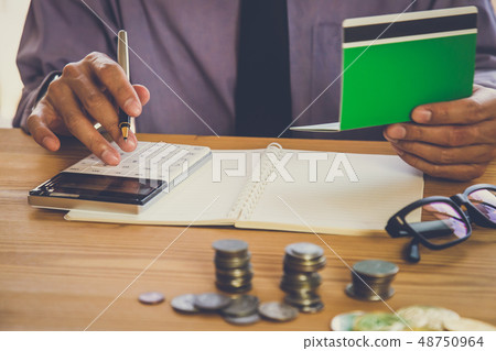 Businessman or accountant working on calculator to Businessman or accountant working on calculator to 48750964