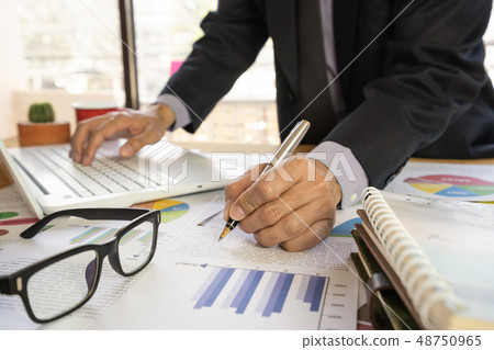 Businessman or accountant working on calculator to Businessman or accountant working on calculator to 48750965