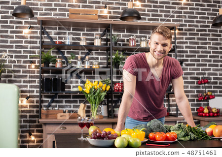Handsome bearded boyfriend smiling while standing in the kitchen 48751461