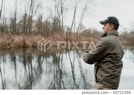 Young man is fishing Young man is fishing 48752398