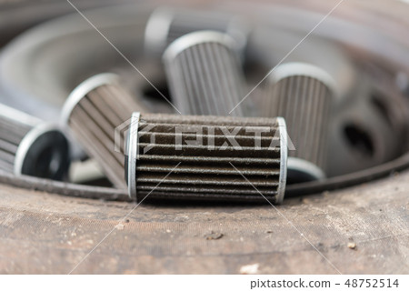 Old lubricant engine oil filter at car garage Old lubricant engine oil filter at car garage 48752514