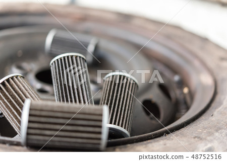 Old lubricant engine oil filter at car garage Old lubricant engine oil filter at car garage 48752516
