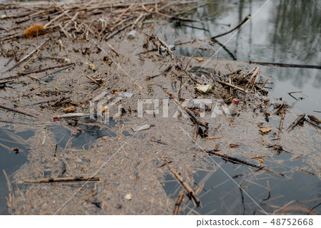 Garbage floating in water Garbage floating in water 48752668