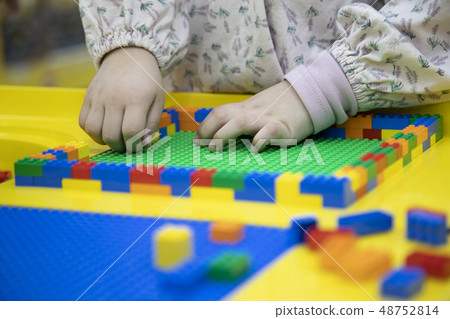 A child concentrating on toy play A child concentrating on toy play 48752814