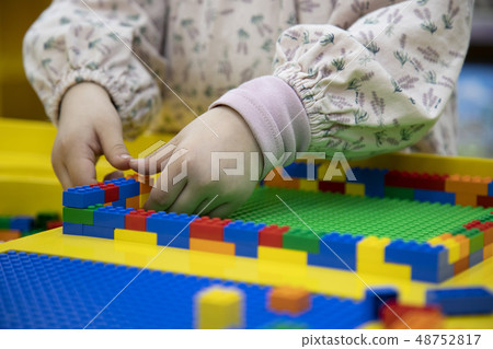 A child concentrating on toy play A child concentrating on toy play 48752817