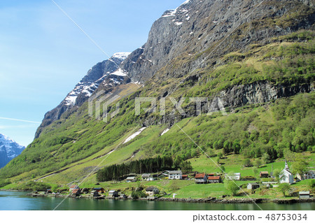 Norwegian fjord landscape under the steep cliff picturesque small town 48753034