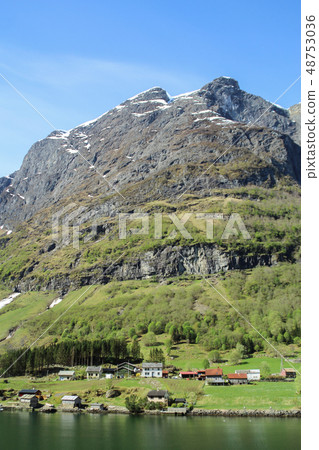 Norwegian fjord landscape under the steep cliff picturesque small town 48753036