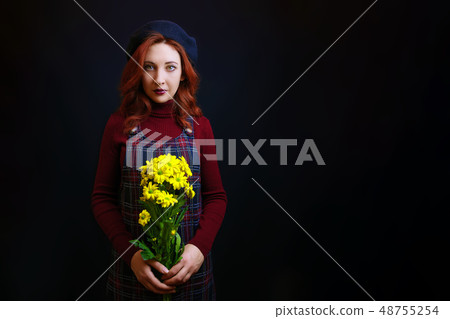 Woman holds a yellow chrysanthemum Woman holds a yellow chrysanthemum 48755254