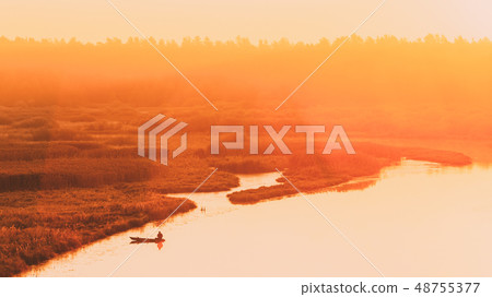 Calm Water Of Lake, River and rowing fishing boat at beautiful sunrise in autumn morning. Fisherman Calm Water Of Lake, River and rowing fishing boat at beautiful sunrise in autumn morning. Fisherman 48755377