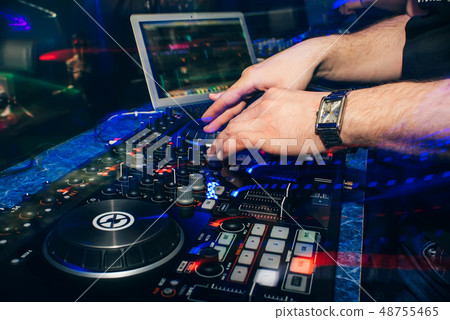 DJ in booth playing in nightclub on background of mixer 48755465