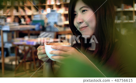 Portrait of asian businesswoman in casual suit drinking in happiness action in modern coffee shop and library, lifestyle concept 48756615