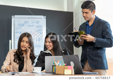 Group Of Asian and Multiethnic Business people with formal suit working and brainstorming together with technology computer in the modern Office, people business group and entrepreneurship concept. 48756617