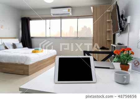 Luxury Interior living room with workspace working with technology tablet, Studio room type of condominium or apartment, service apartment and Accommodations Concept 48756656