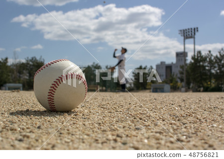 Baseball player throwing high up in the sky 48756821