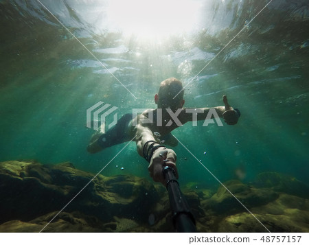 Underwater selfie shot with selfie stick. Deep Underwater selfie shot with selfie stick. Deep 48757157