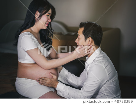 Pregnant women with husband feeling happy Pregnant women with husband feeling happy 48758399