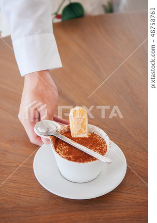 Italian Tiramisu in white cup with ladyfinger 48758761