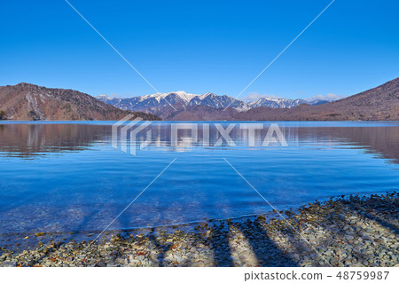 Mountains from the south shore of Lake Chuzenji Lake to the northwest of the remaining snow (such as Mt. Shirane) 48759987