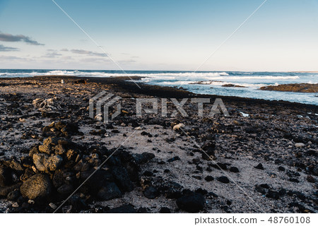 Scenic view of rocky beach  at sunset 48760108