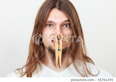 Man with clothespin on nose 48762295