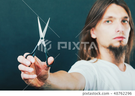 Hairstylist with scissors in hand Hairstylist with scissors in hand 48762296