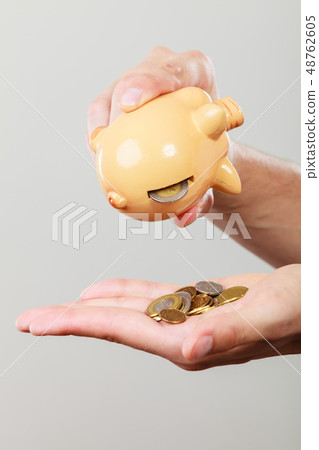 Male hands with coins and piggybank Male hands with coins and piggybank 48762605