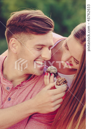 Smiling couple feeding each other. Smiling couple feeding each other. 48762633