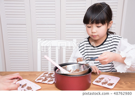 Girl making handmade chocolate Girl making handmade chocolate 48762980