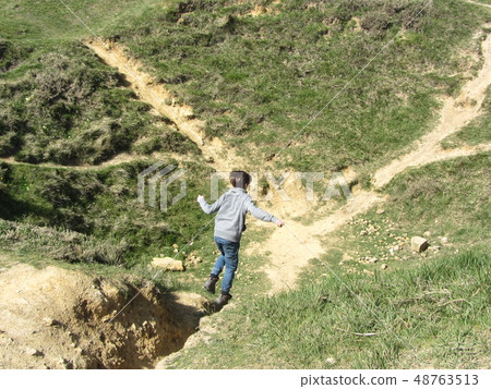 boy running to bomb craters WW2 France 48763513