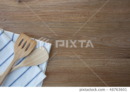 Wooden kitchen utensils and linen kitchen towels  48763601